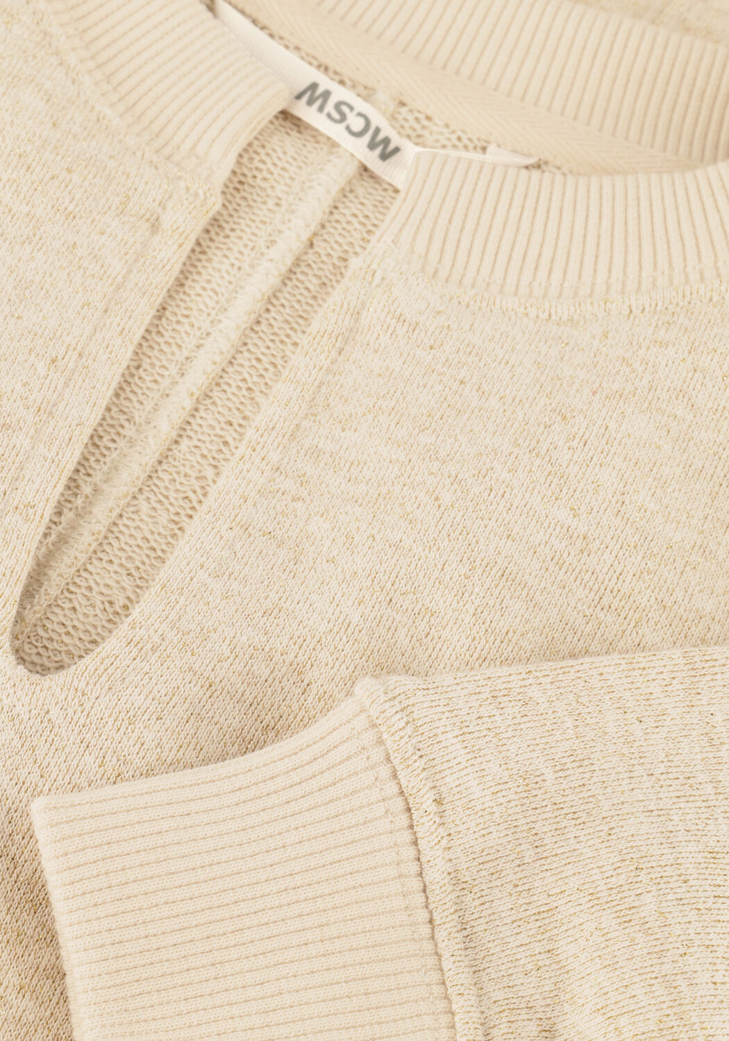 Pink Baby Elise oat beige knit mini dress with notch neckline, showcasing soft fabric and stylish fit on a model.