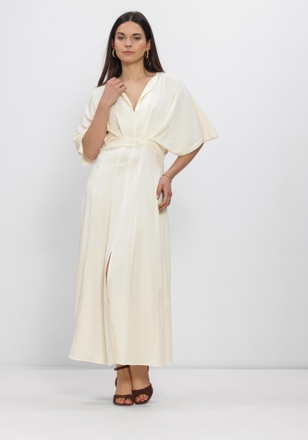 Pink Baby Valeria Draped V-Neck Ivory Maxi Dress displayed on a hanger with flowing fabric and elegant V-neck design.