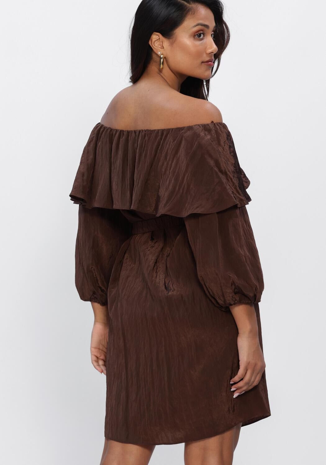 Pink Baby Rosalyn off-shoulder ruffle mini dress in chocolate brown, featuring a stylish off-shoulder design and ruffle details.