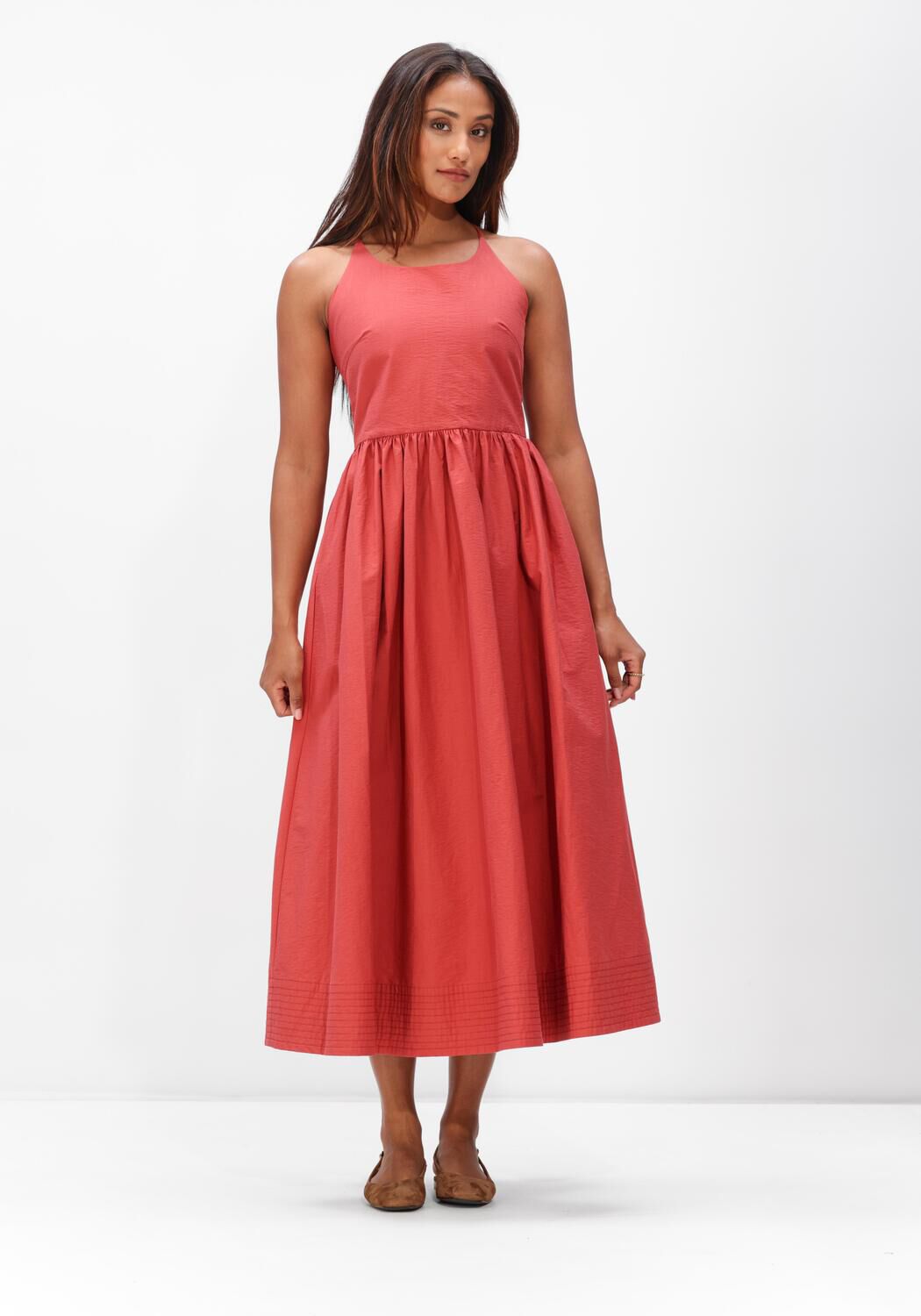 Pink Baby Camilla cross-back midi dress in coral fabric, featuring a stylish design and flowing silhouette.