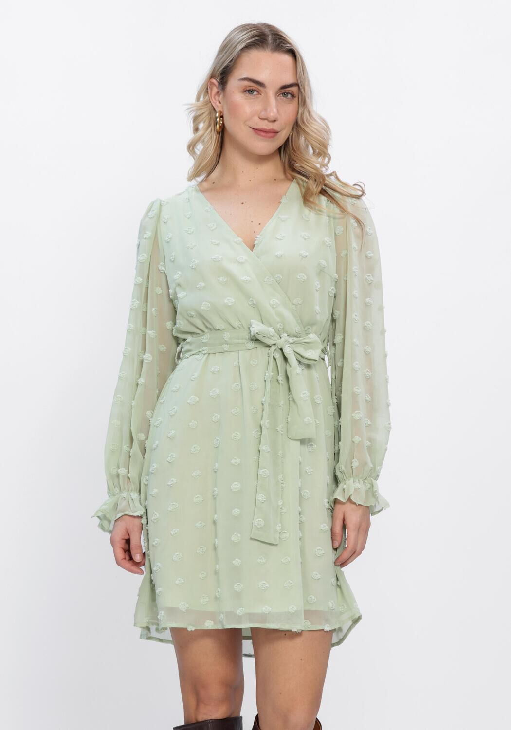 Pink Baby Elodia Dobby Wrap Mini Dress in sage green, showcasing a stylish wrap design and lightweight fabric.
