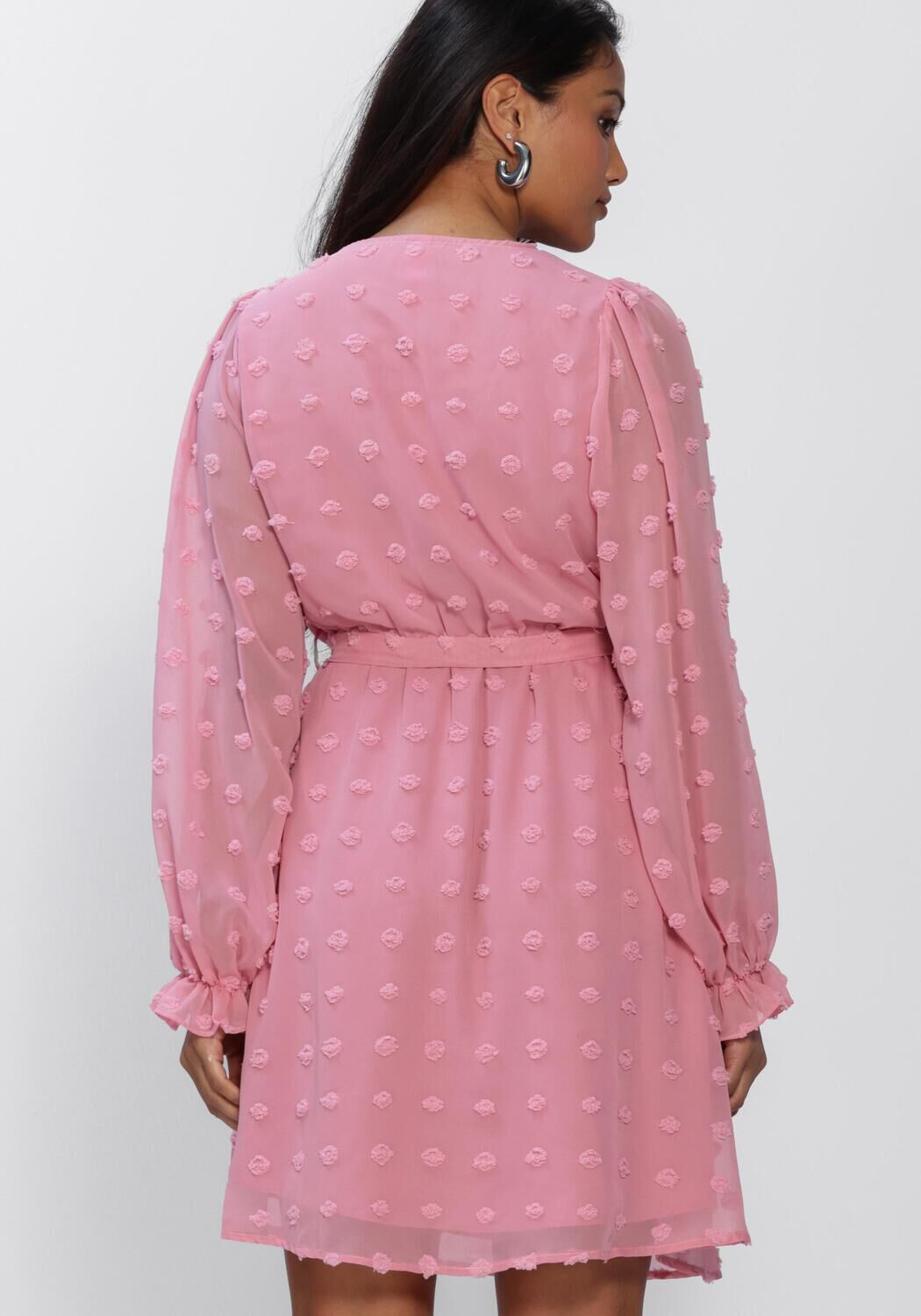 Pink Baby Rona Dobby Wrap Mini Dress in blush pink, featuring a stylish wrap design and short sleeves.