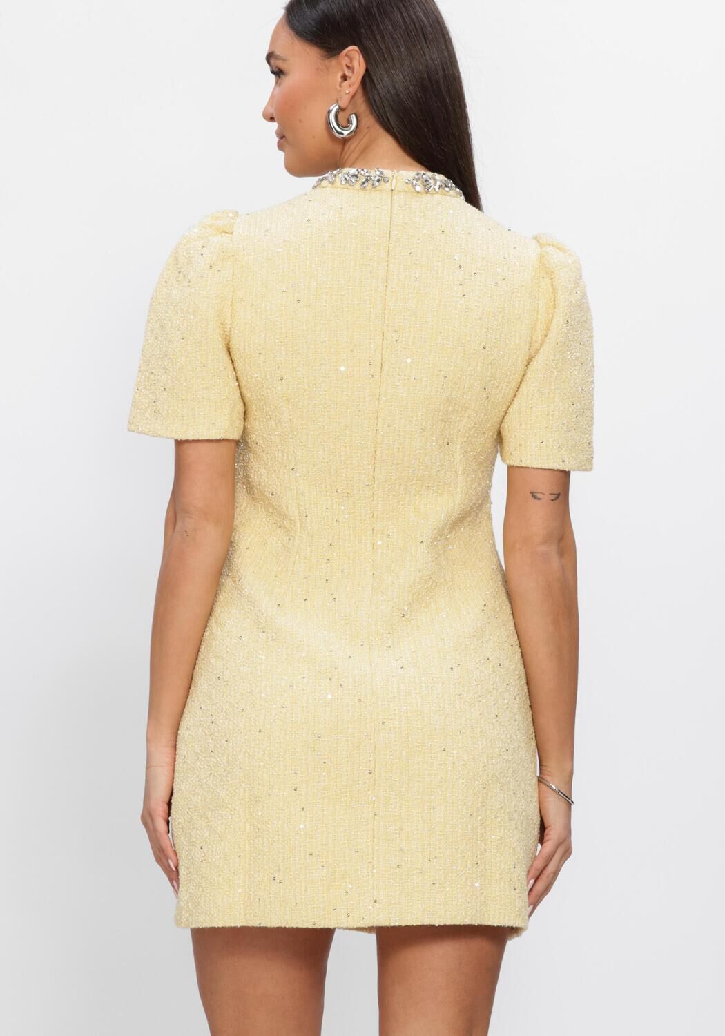 Pink Baby Celine embellished yellow tweed mini dress with intricate details and a soft, textured fabric design.