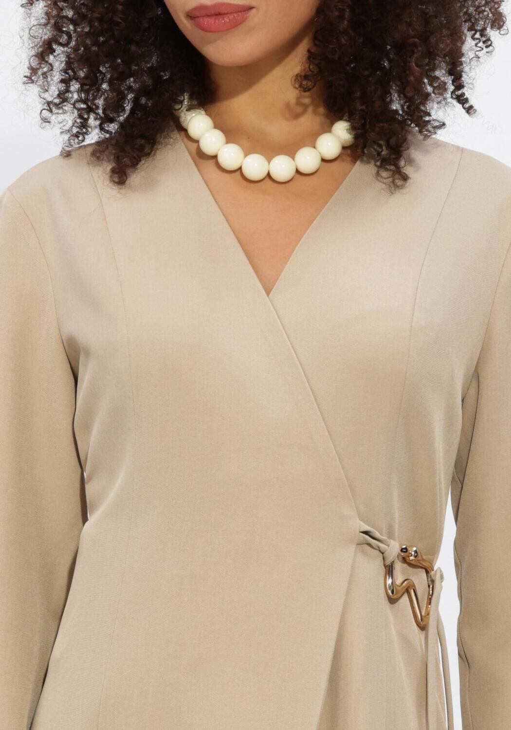 Beige Cindy buckle-detail wrap mini dress by Pink Baby, showing the stylish dress with buckle accents and a fitted silhouette.