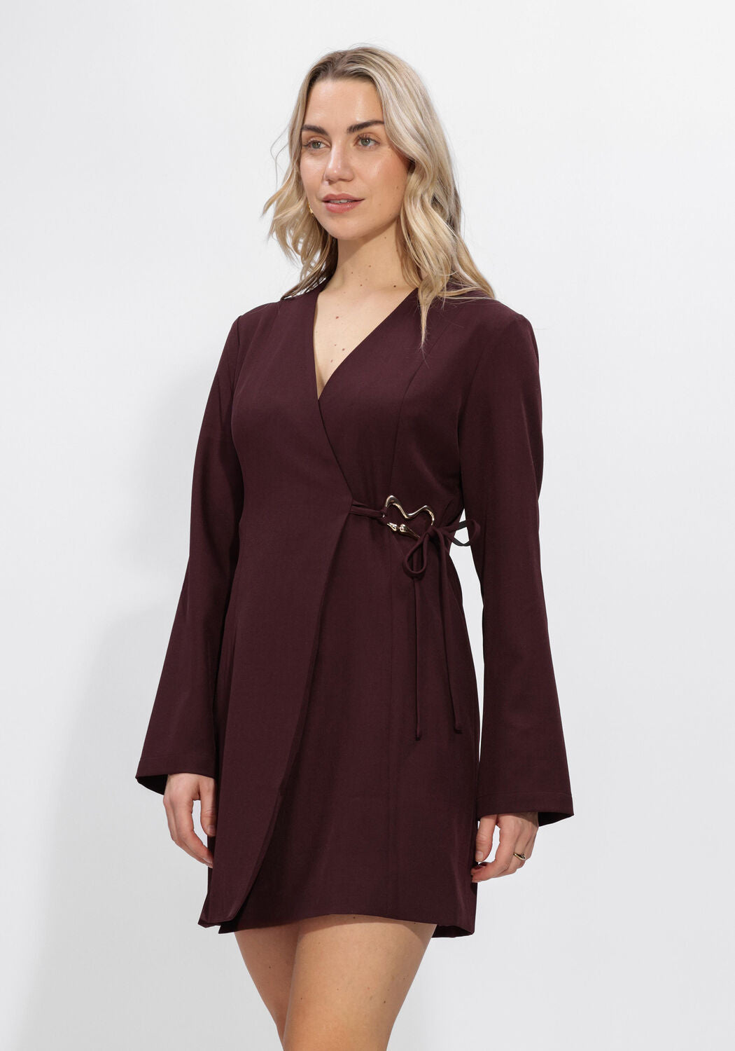 Pink Baby Viviana Hardware Wrap Mini Dress in Burgundy, featuring a stylish design and hardware details, shown on a model.