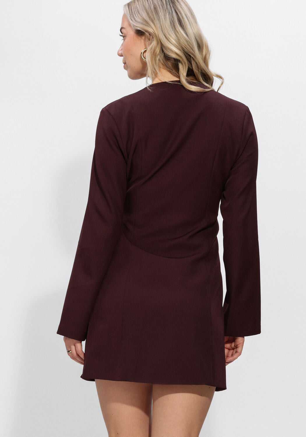 Pink Baby Viviana Hardware Wrap Mini Dress in Burgundy displayed on a hanger with detailed hardware accents.