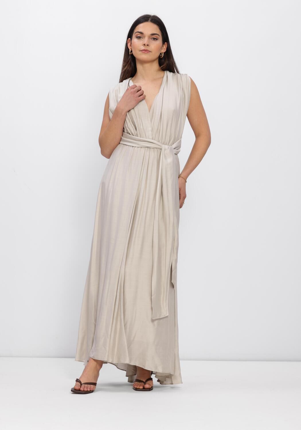 Beige Valentina Pleated Cross-Back Maxi Dress by Pink Baby, featuring flowing fabric and stylish cross-back design.