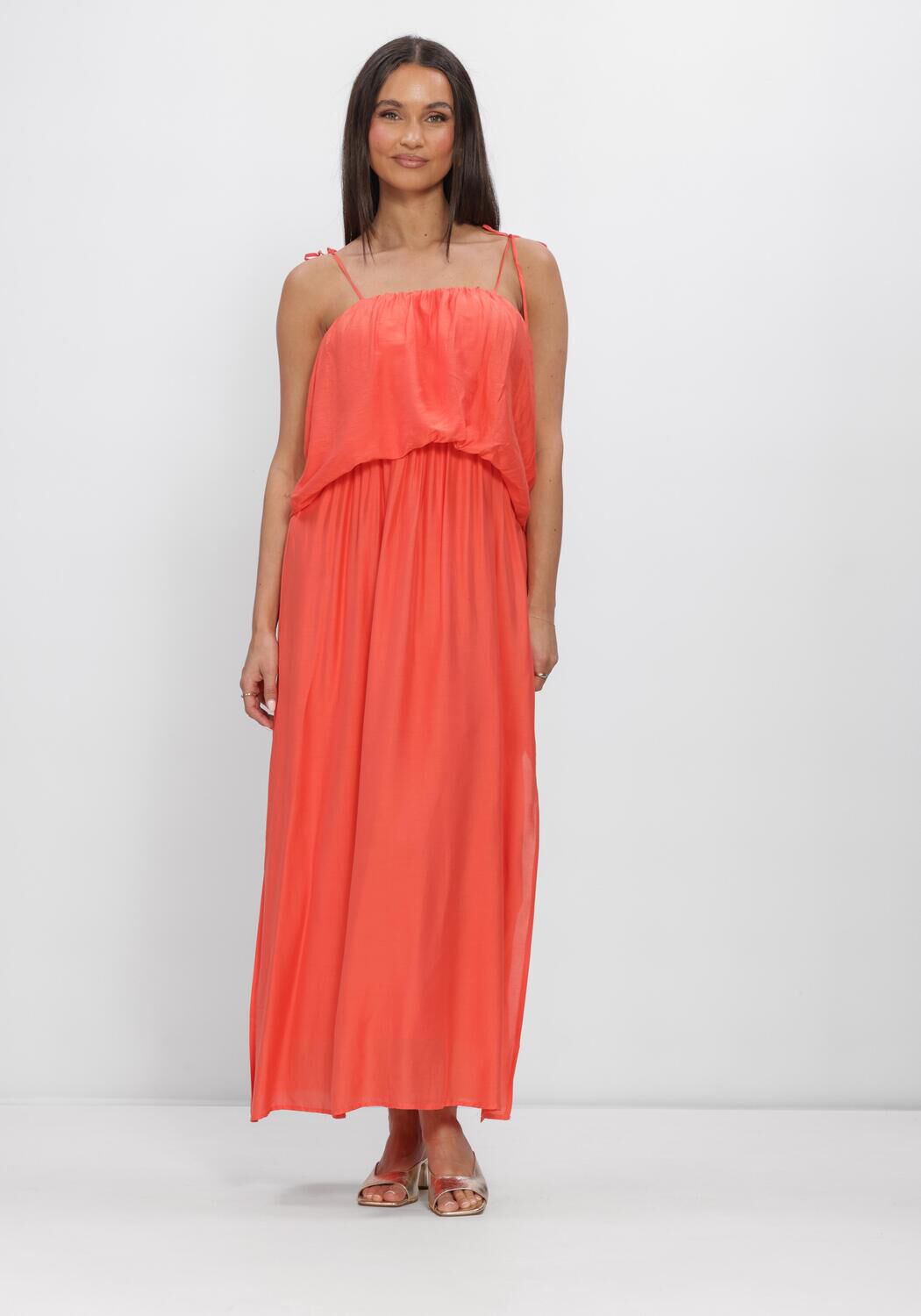 Pink Baby Seraphina flowing layered maxi dress in coral with ruffled details and a relaxed, elegant fit.