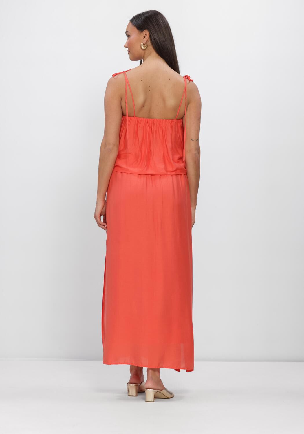 Pink Baby Seraphina flowing layered maxi dress in coral, featuring a lightweight, elegant design with ruffled details.