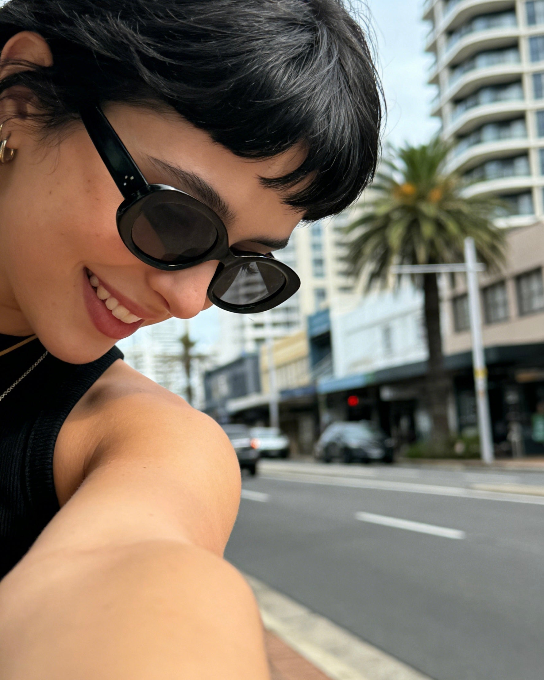 Pink Baby The Flynn black sunglasses with round frames and dark lenses, stylish eyewear for a trendy look.