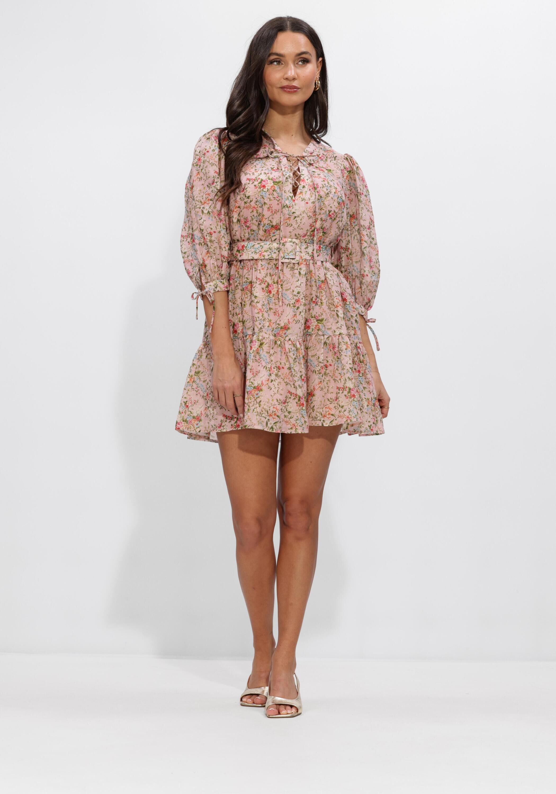 Pink Baby Eloisa belted floral mini dress in blush pink, featuring a fitted waist and lightweight fabric with a floral print.