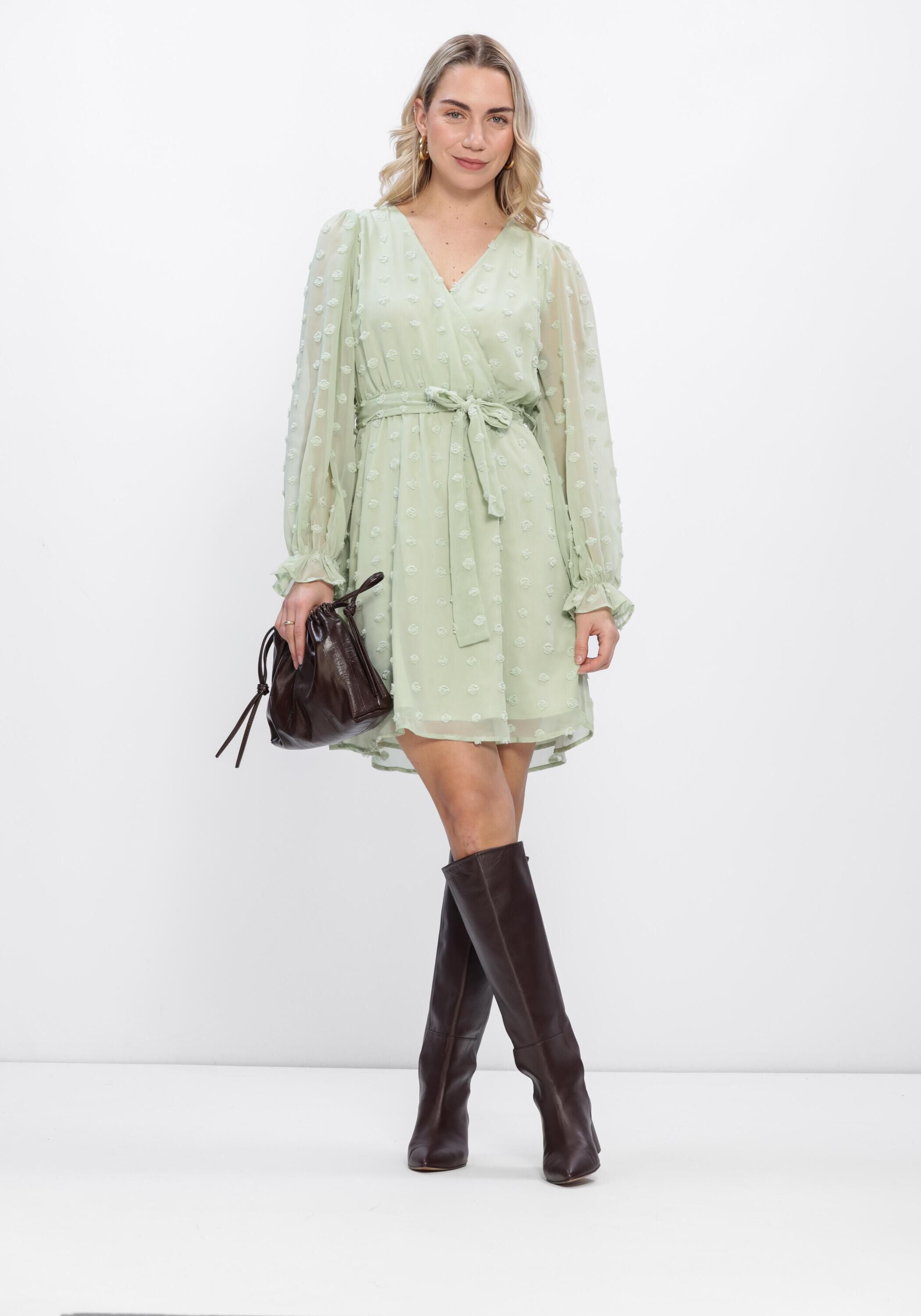 Pink Baby Elodia Dobby Wrap Mini Dress in sage green with a stylish wrap design and short sleeves.