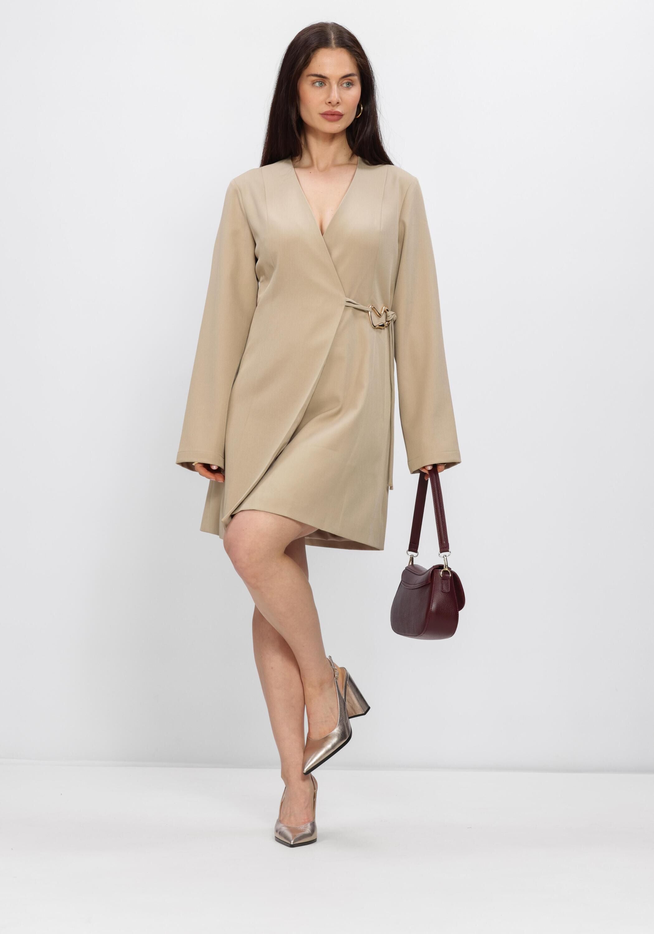 Beige Cindy buckle-detail wrap mini dress by Pink Baby, showing close-up of the dress with buckle accents and wrap design.