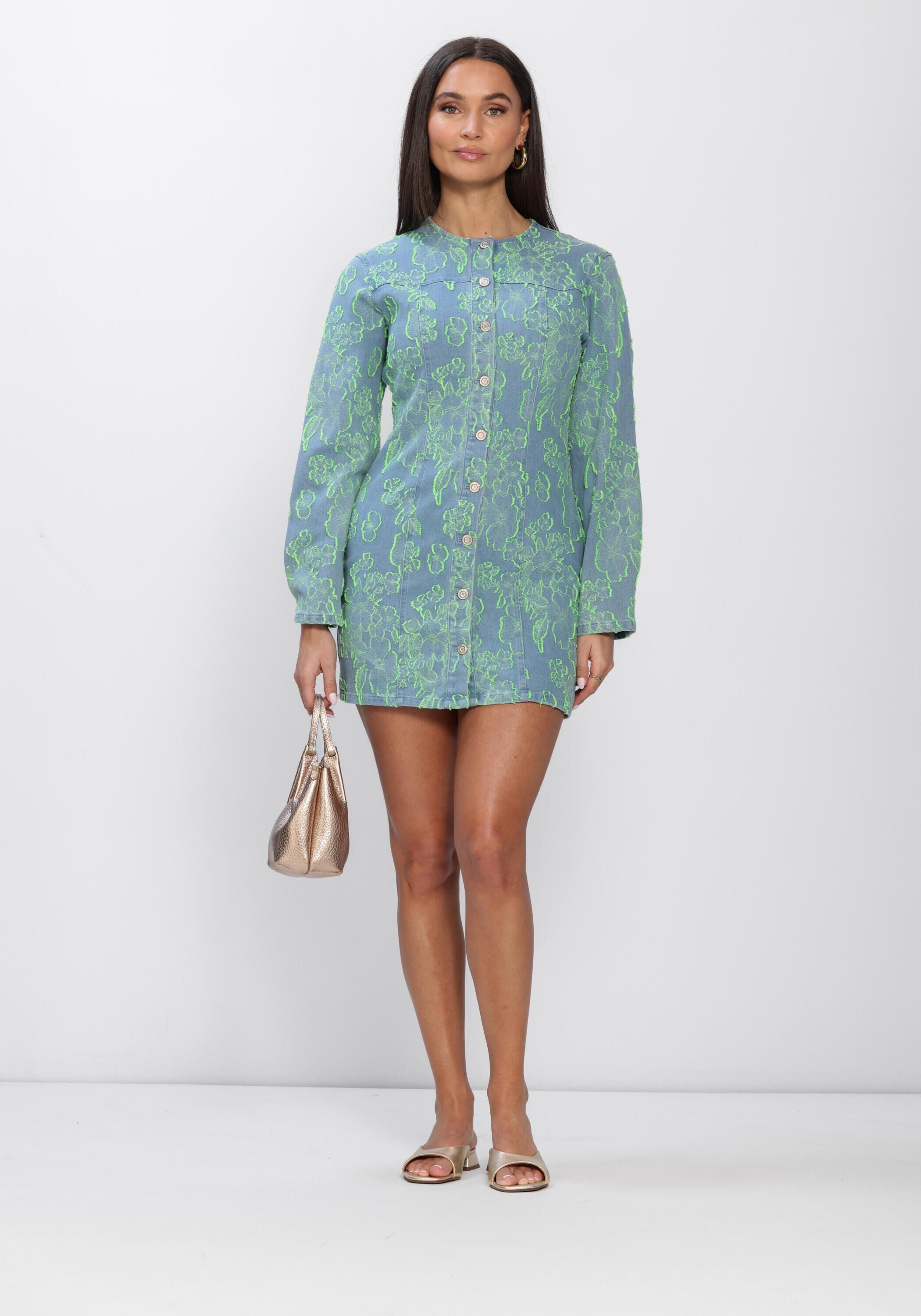 Pink Baby Freya Floral Denim Mini Dress in blue and green with a sleeveless design and floral pattern, displayed on a hanger.