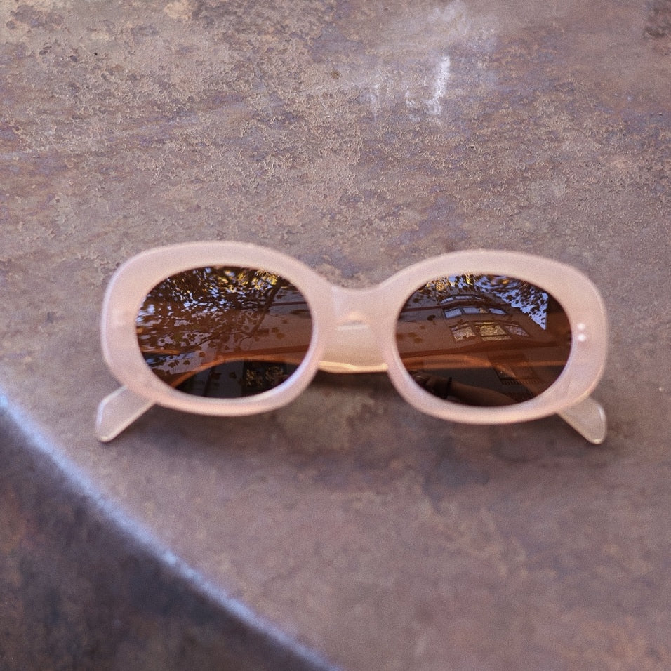Pink Baby Flynn pink sunglasses with rounded frames and tinted lenses, stylish and protective eyewear for kids.