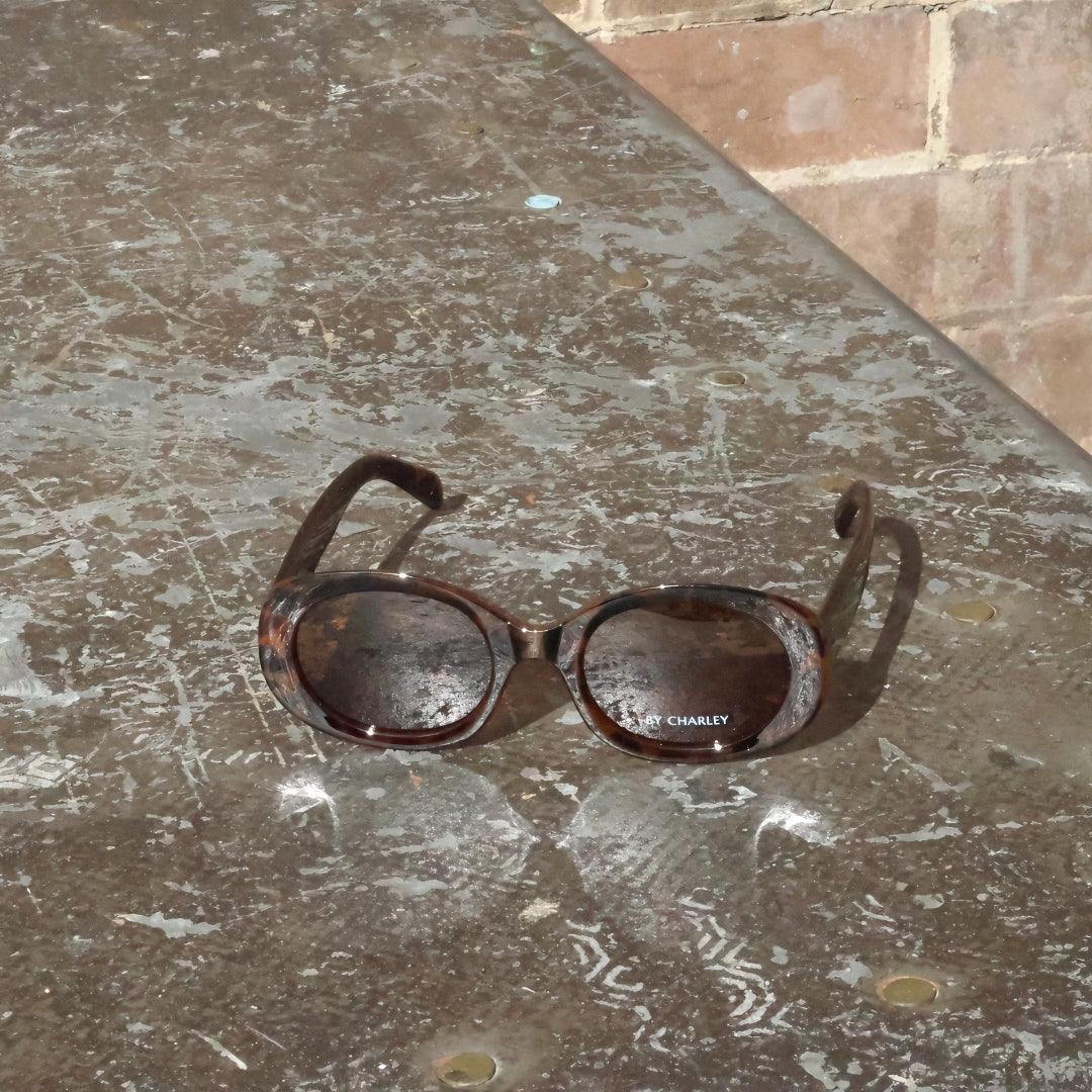 Pink Baby The Flynn tortoiseshell sunglasses with rounded frames and dark lenses, stylish eyewear for sun protection.