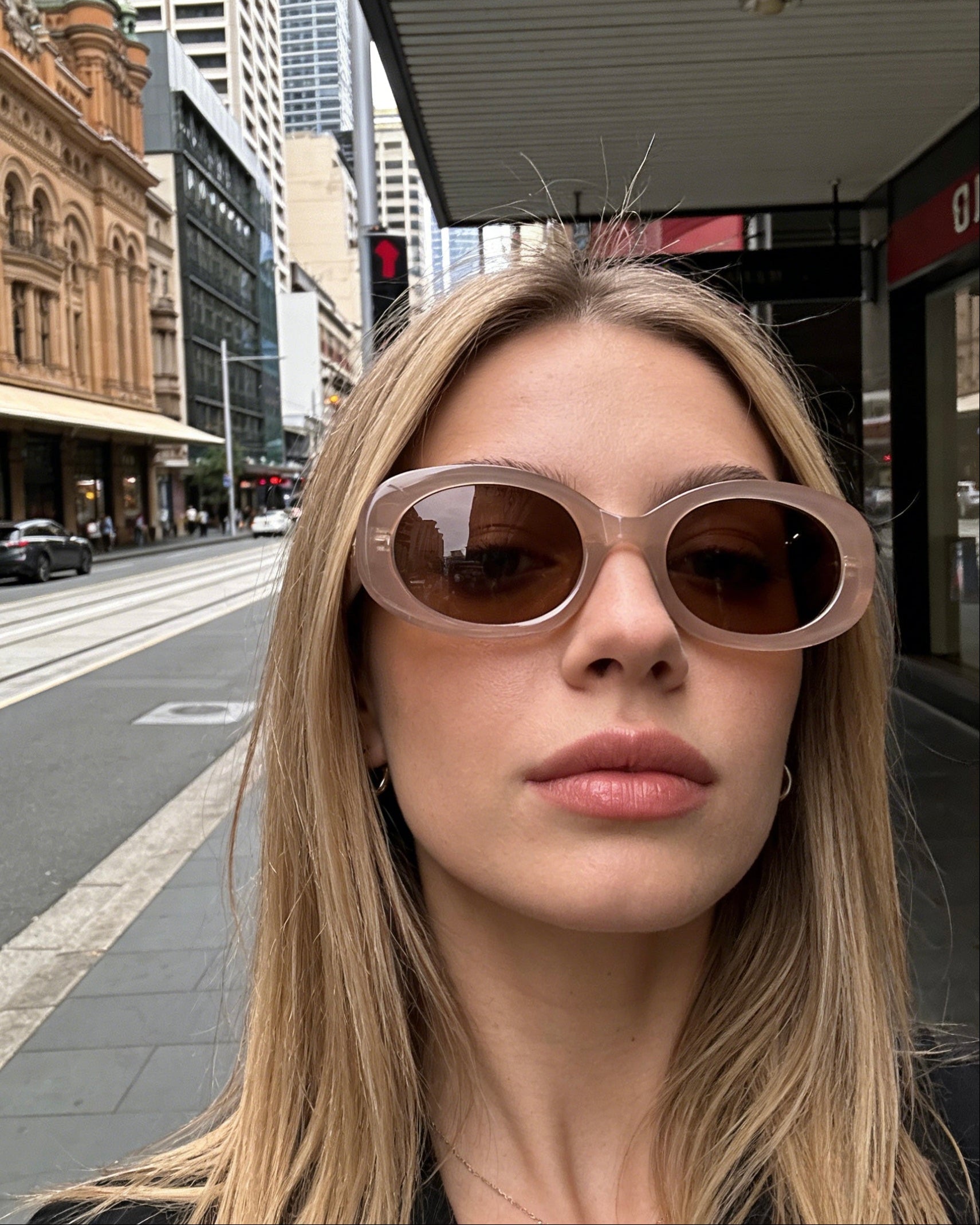 Pink Baby Flynn sunglasses with pink frames and dark tinted lenses, styled with a fashionable and playful design.