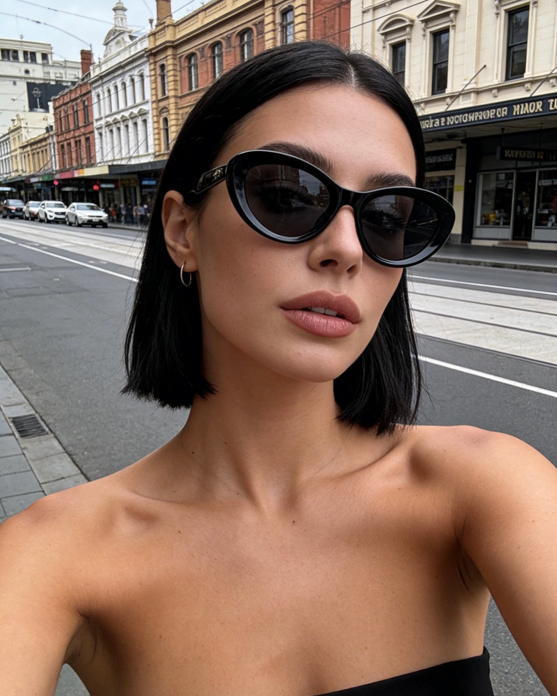 Pink Baby The Freesia black cateye polarized sunglasses with sleek black frames and dark lenses.