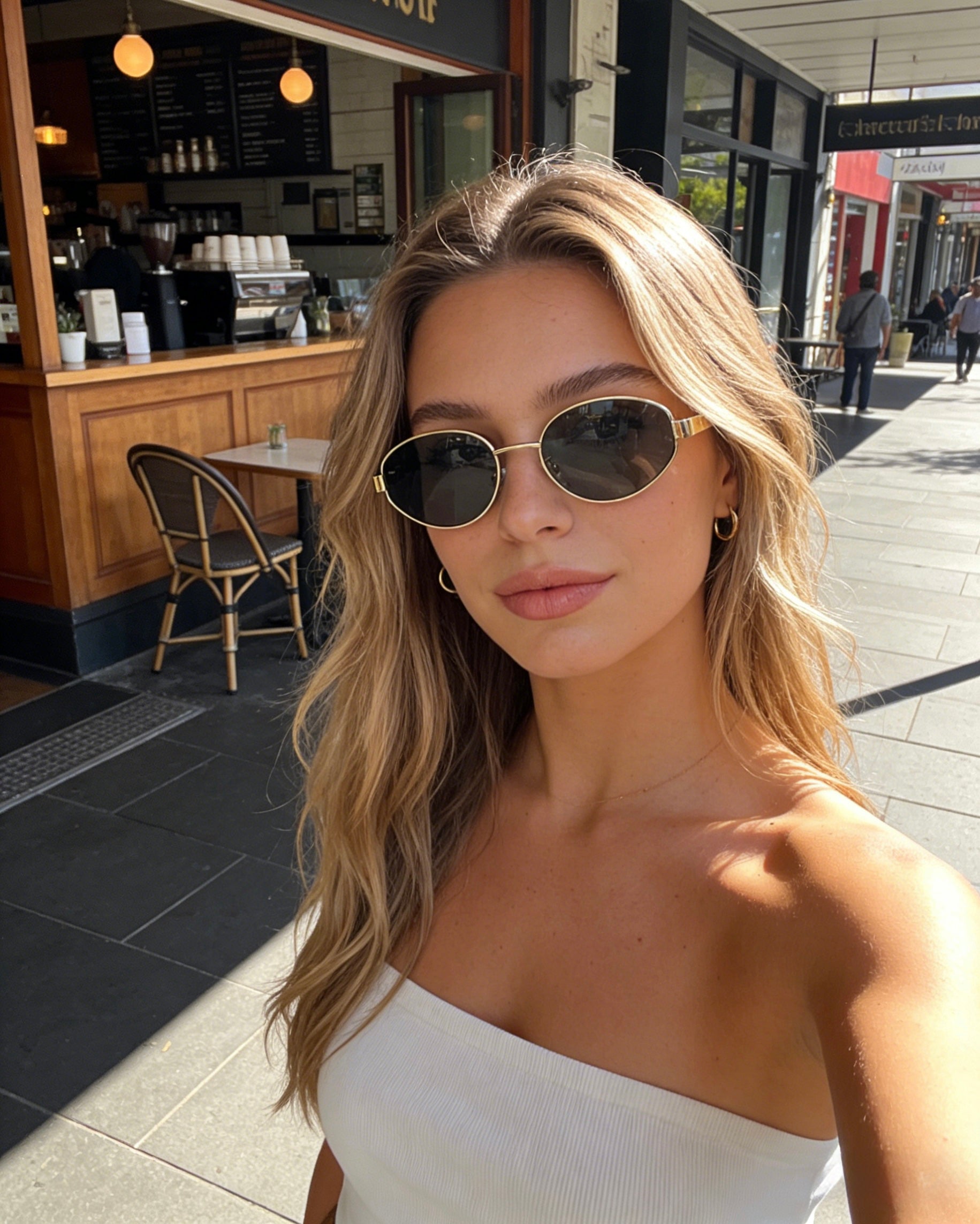 Pink Baby Hollis black oval polarized sunglasses with classic frame design for stylish sun protection.