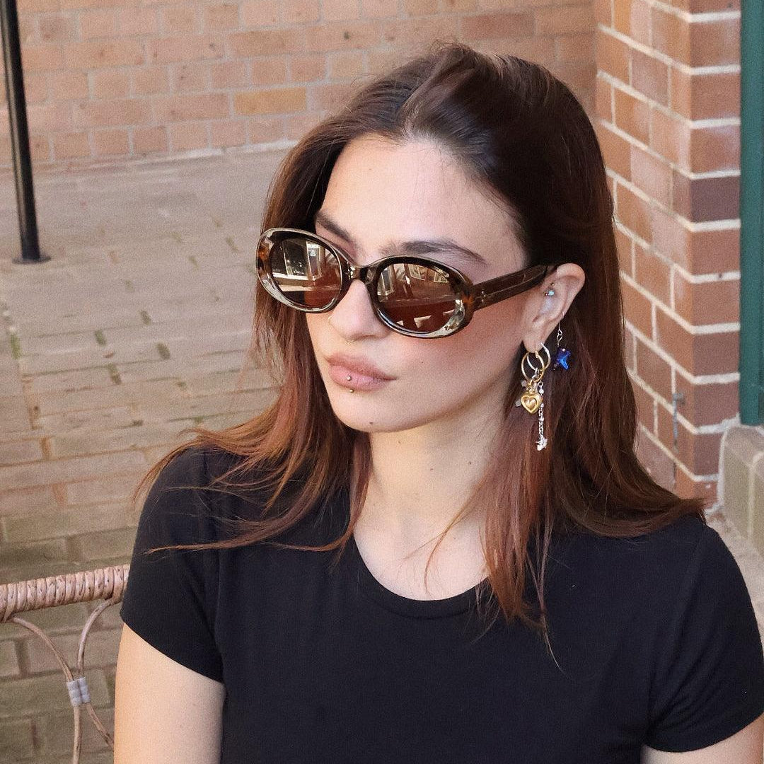 Pink Baby The Flynn tort sunglasses with rounded frames and dark tinted lenses, stylish eyewear for adults.