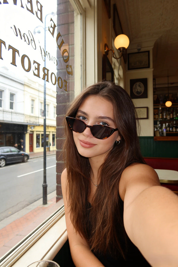 Pink Baby The Juno tort sunglasses with rounded frames and dark tinted lenses, stylish eyewear for sun protection.