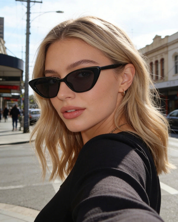 Pink Baby The Juno black sunglasses with sleek frames and tinted lenses, stylish eyewear for sun protection.