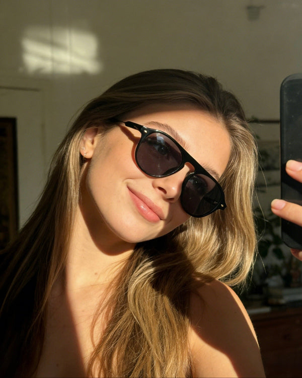 Pink Baby The Riley black sunglasses with sleek frame and tinted lenses, stylish eyewear for sun protection.