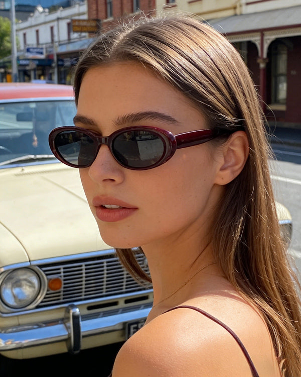 Pink Baby The Kiara hawthorn sunglasses with round pink-tinted lenses and sleek black frames, stylish and protective eyewear.
