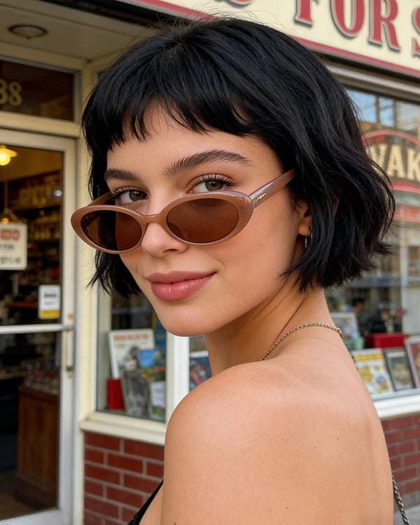 Pink Baby The Kyra cinnamon sunglasses with rounded frames and tinted lenses, stylish eyewear for sunny days.