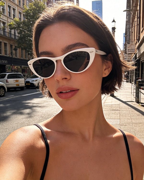 Pink Baby The Bailey white sunglasses with rounded frames and tinted lenses, stylish eyewear for a fashionable look.