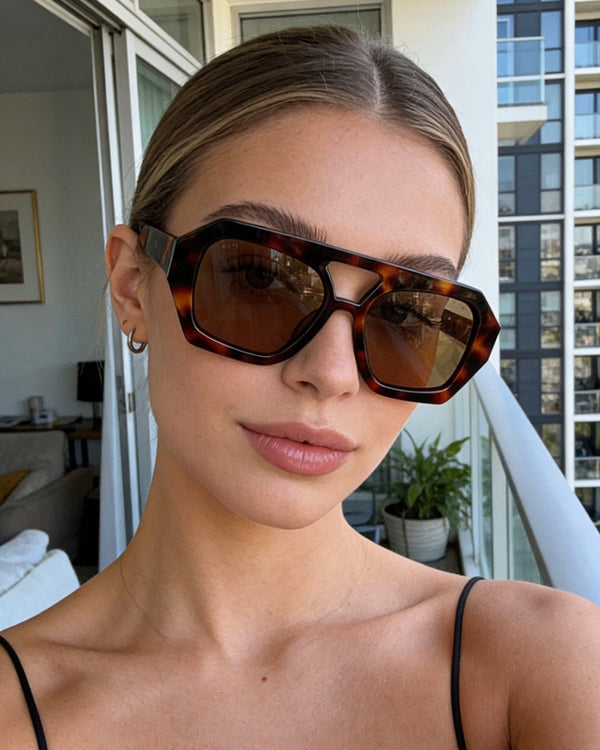 Pink Baby The Orin sunglasses with round black lenses and pink frame, stylish eyewear for sunny days.