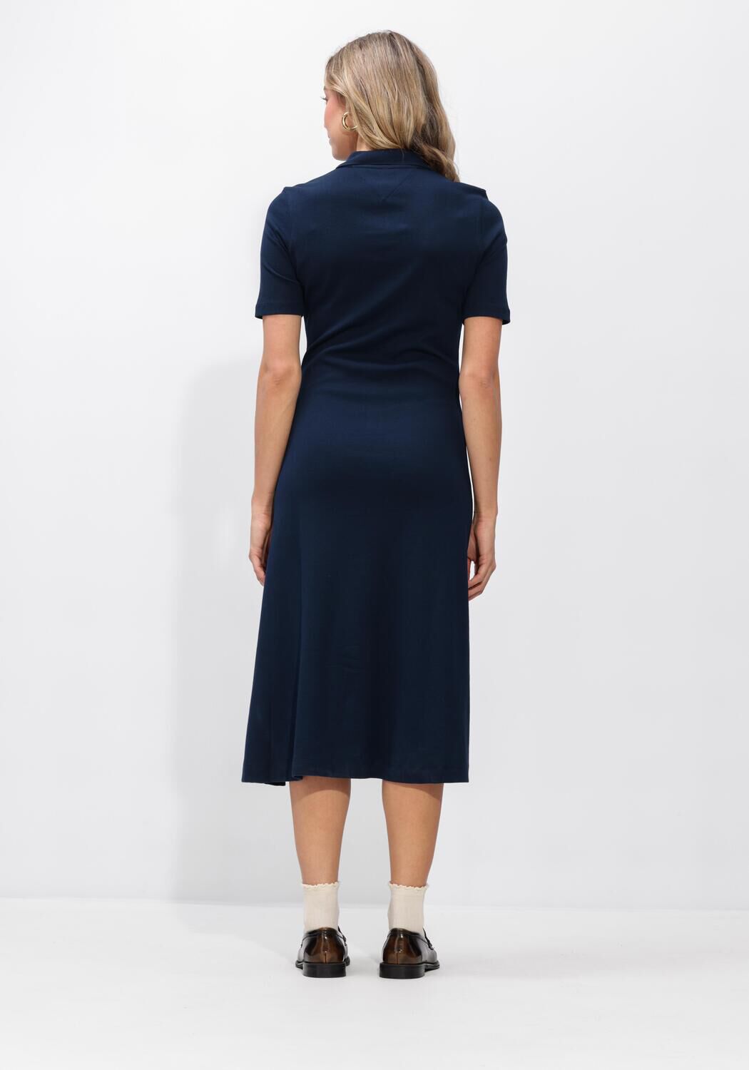 Pink Baby Lucia button-front collared navy midi dress hanging on a display with buttons and collar details.