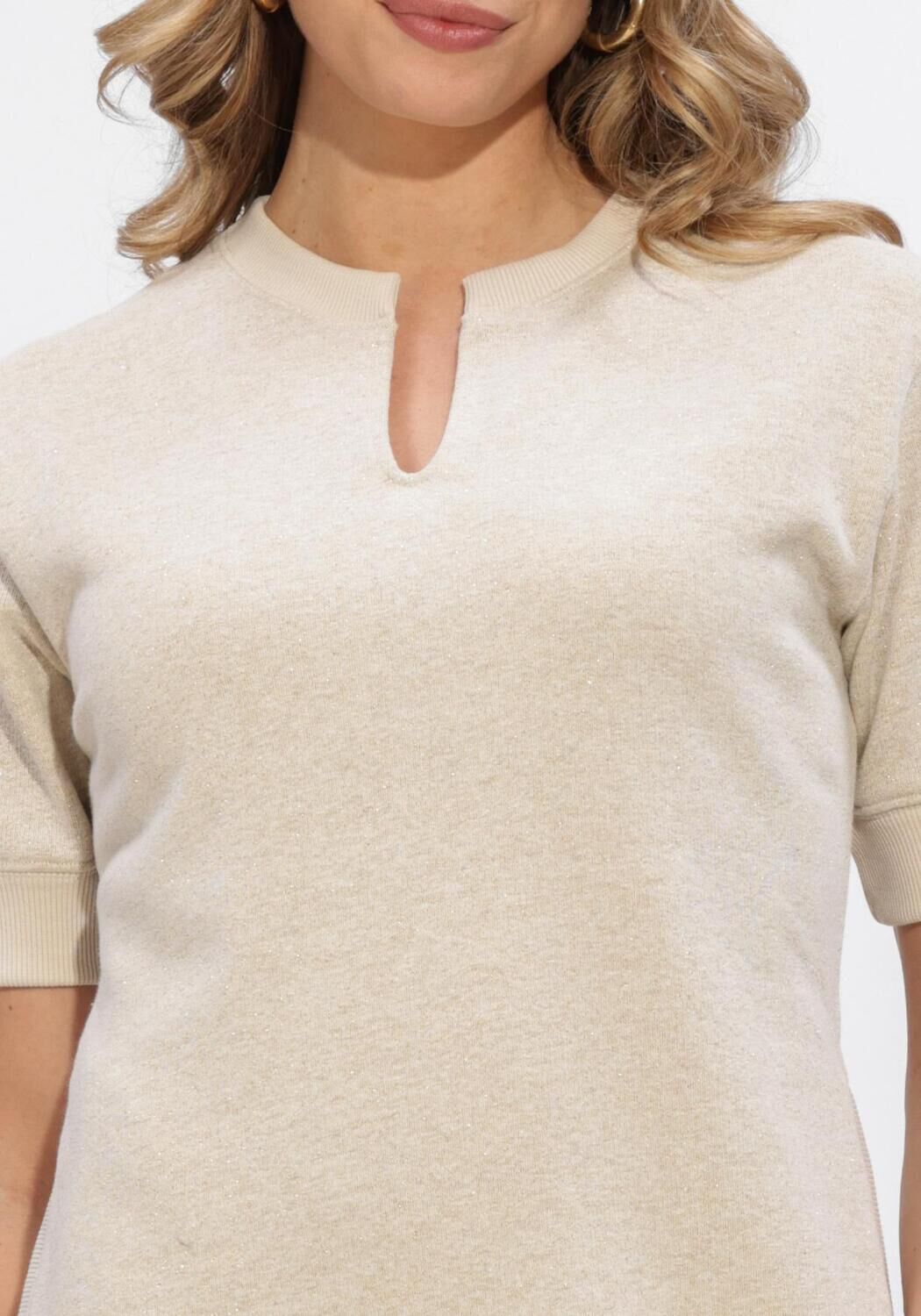 Pink Baby Elise notch-neck knit mini dress in oat beige, featuring a stylish notch neckline and cozy knit fabric.