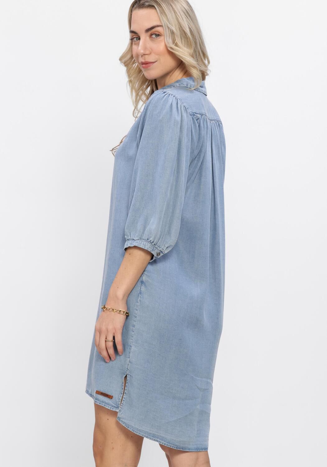 Light blue Normi denim shirt dress by Pink Baby with button front and collar, casual and stylish for everyday wear.
