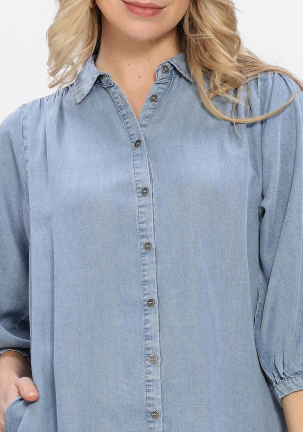 Light blue Normi button-front denim shirt dress by Pink Baby, featuring a classic collar and front button closure.