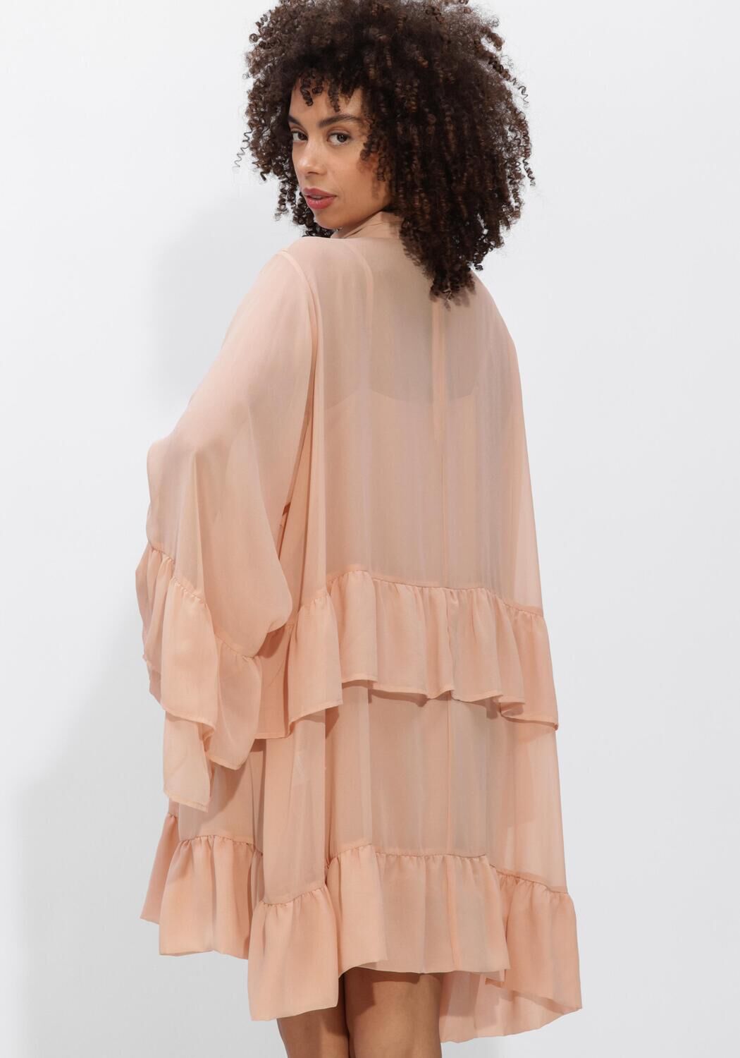Pink Baby Celeste tiered ruffle mini dress in blush pink, featuring layered ruffles and a delicate feminine design.