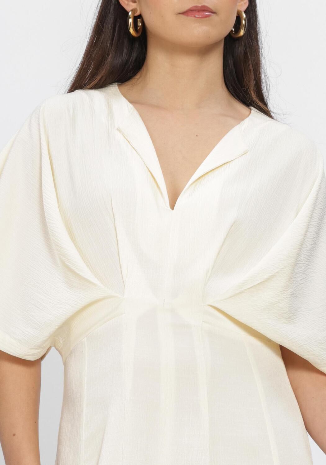 Pink Baby Valeria Draped V-Neck Maxi Dress in ivory, flowing fabric with elegant draping and a V-neckline.