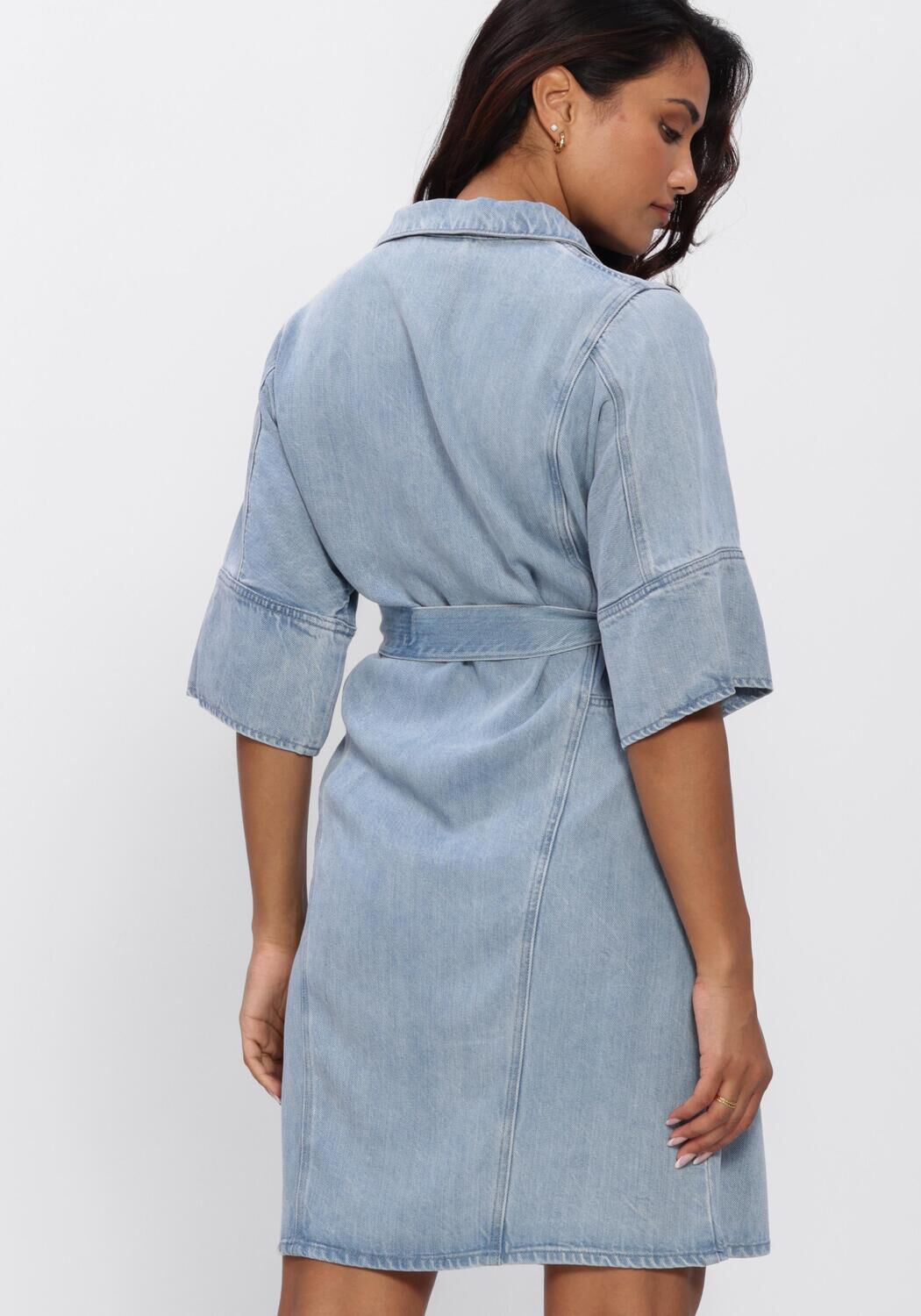 Light blue Dona belted denim mini dress by Pink Baby, featuring a stylish fit and casual design, shown on a model.