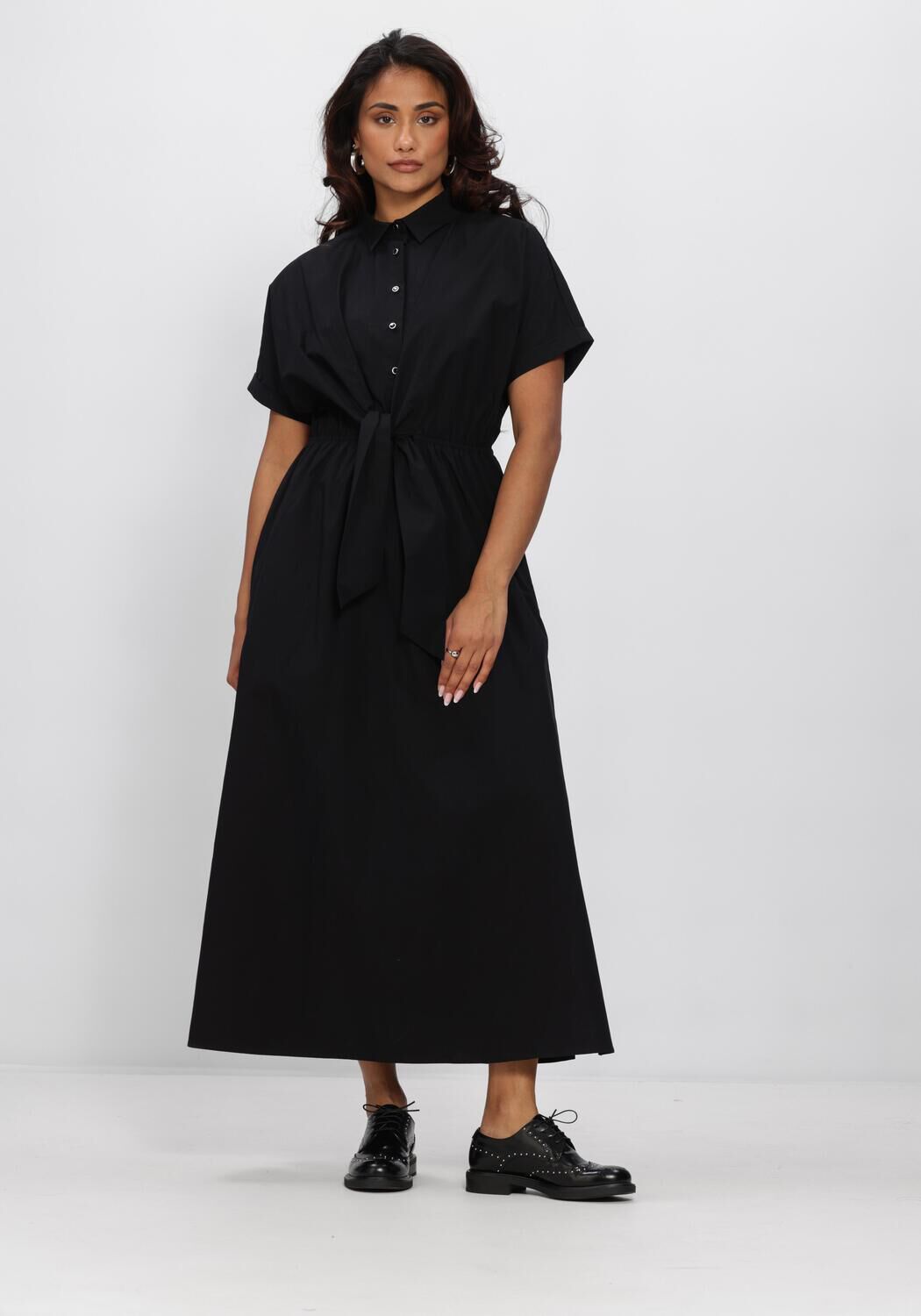 Black Celina tie-waist shirt maxi dress by Pink Baby, featuring a relaxed fit and stylish design, displayed on a hanger.