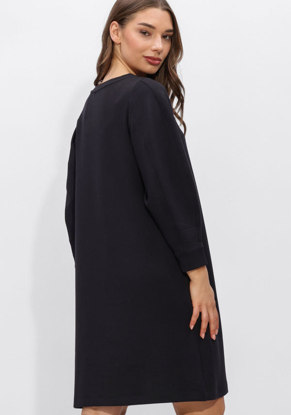 Pink Baby Helena long-sleeve black shift dress displayed on a hanger, showcasing its classic silhouette and elegant design.