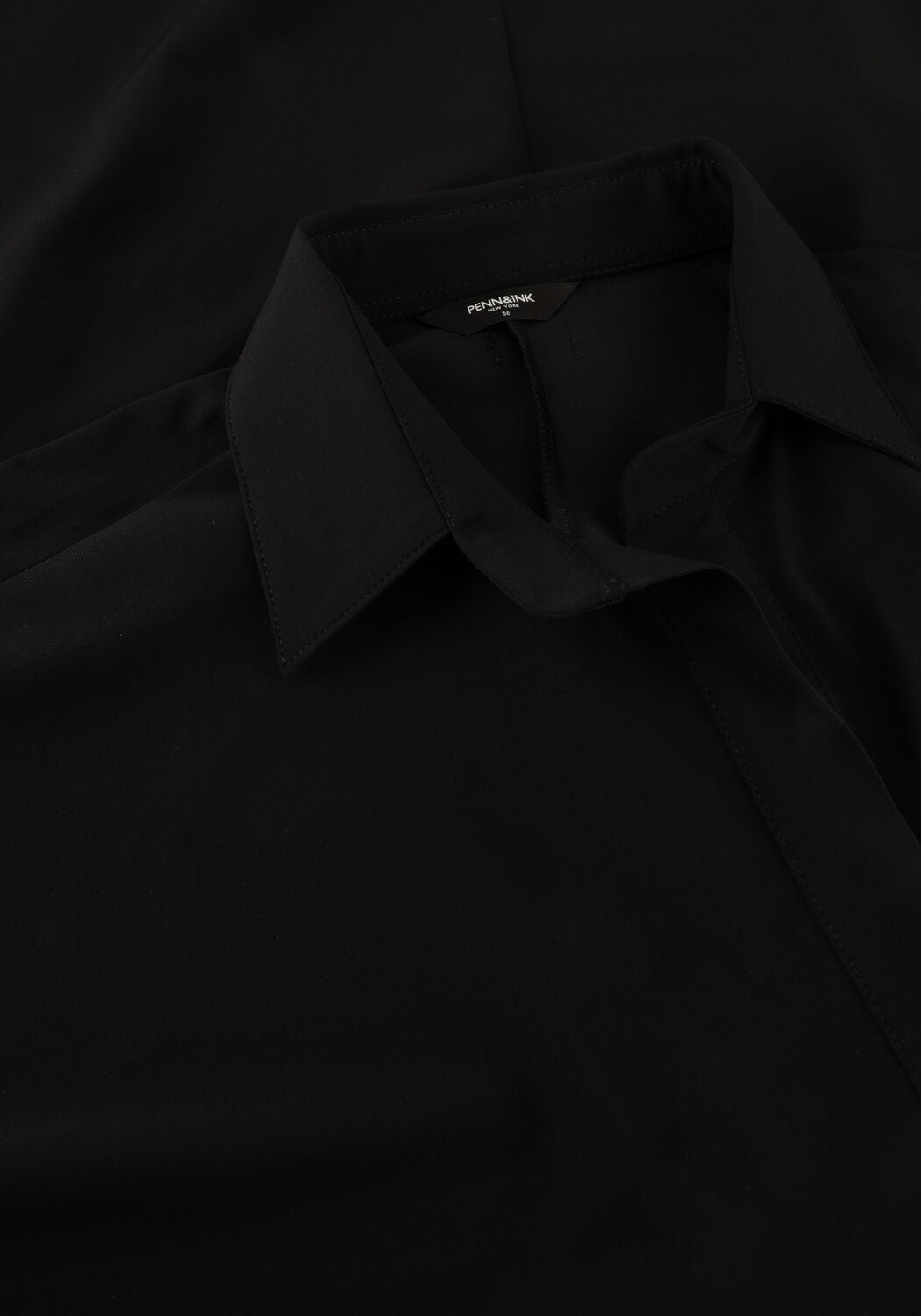 Pink Baby Alexa relaxed polo midi dress in black, featuring a comfortable fit and classic polo collar, shown on a model.