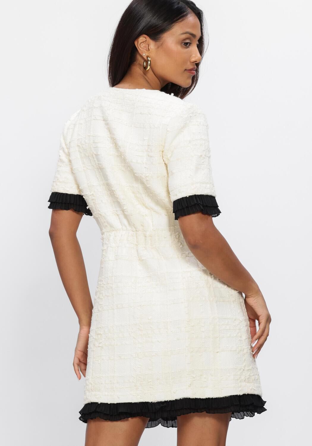Pink Baby Colette textured zip mini dress in ivory, featuring a fitted silhouette and stylish design, shown on a model.