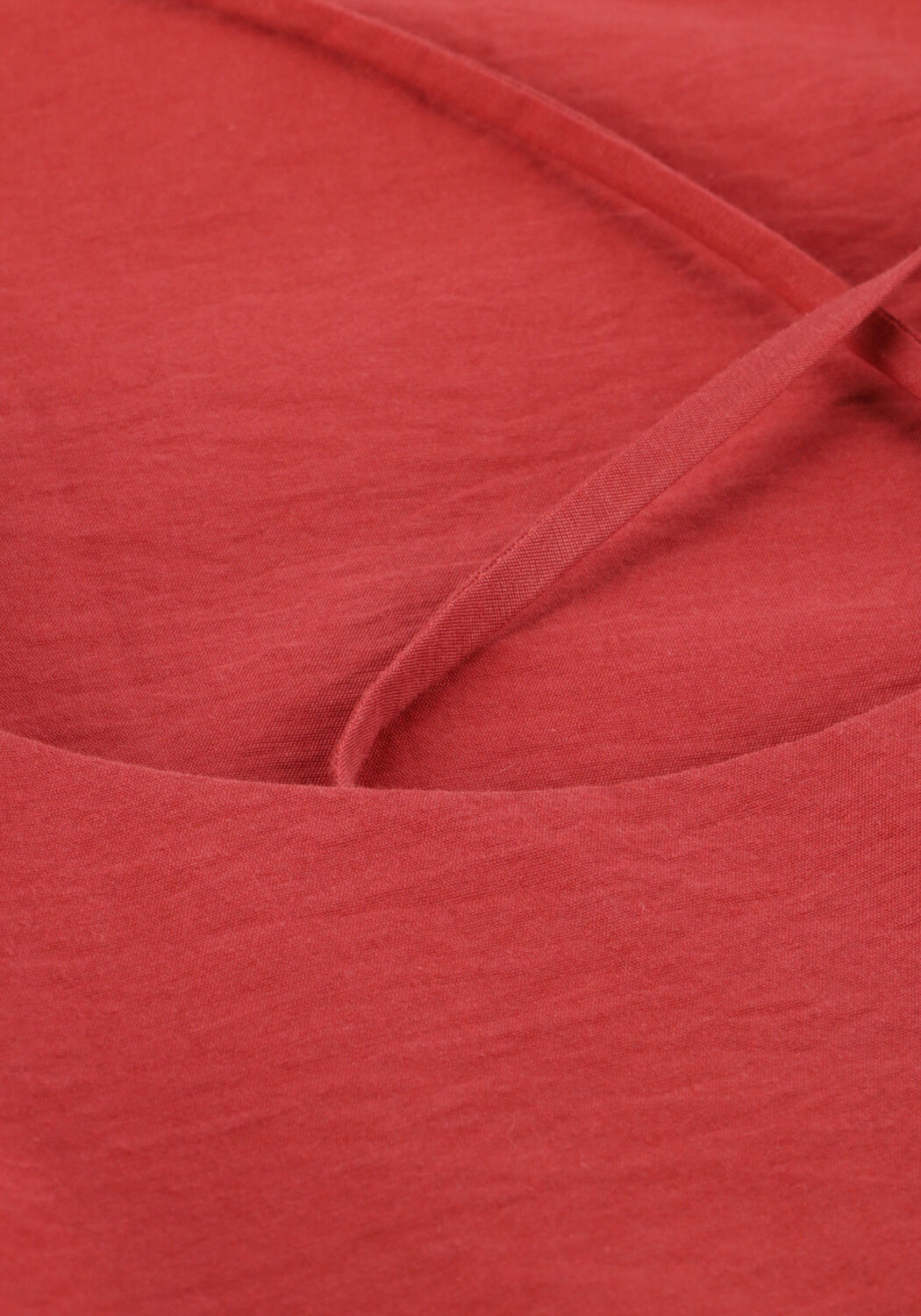 Pink Baby Camilla cross-back midi dress in coral fabric, featuring a flowing silhouette and stylish back design.