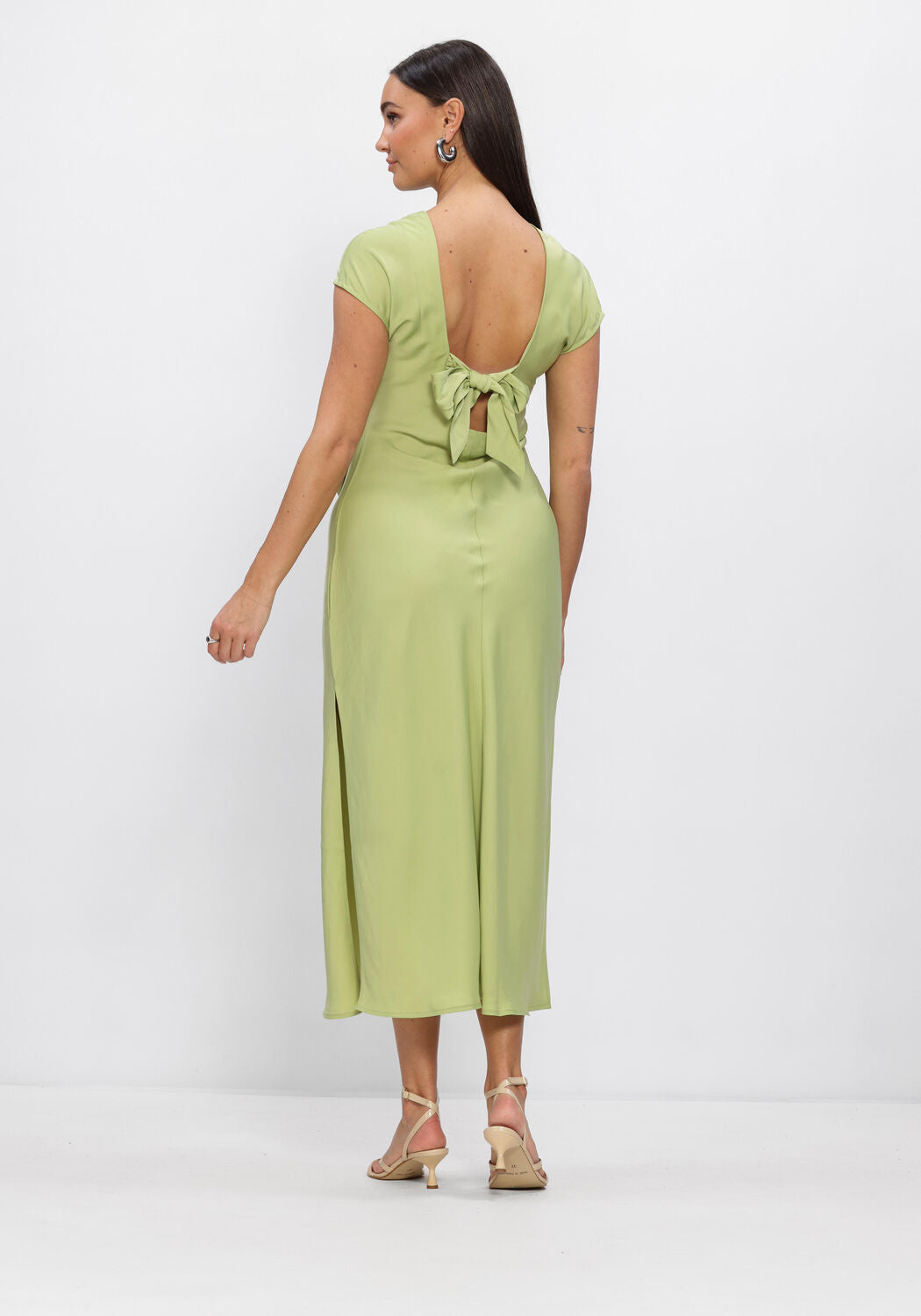 Pink Baby Amalia open-back satin midi dress in sage green, featuring a flowing design and elegant open-back detail.