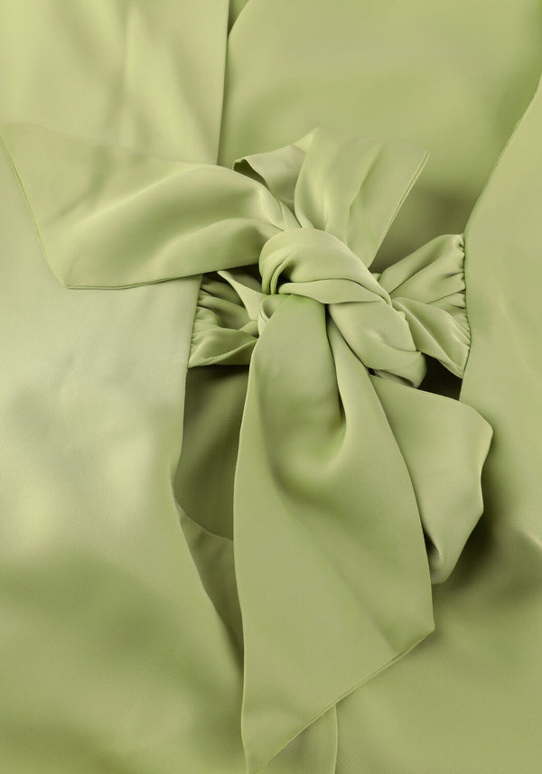 Pink Baby Amalia open-back satin midi dress in sage green, featuring a flowing silhouette and elegant design.
