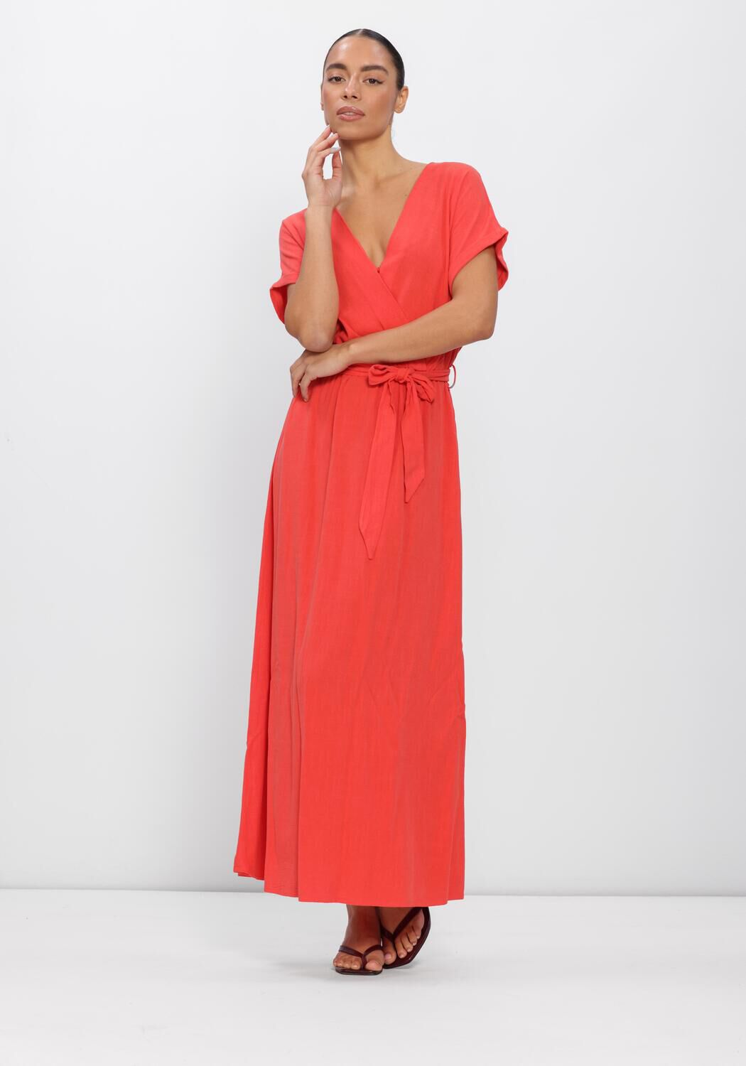 Pink Baby coral Alina belted wrap maxi dress with a flowing silhouette and waist belt, perfect for elegant summer wear.