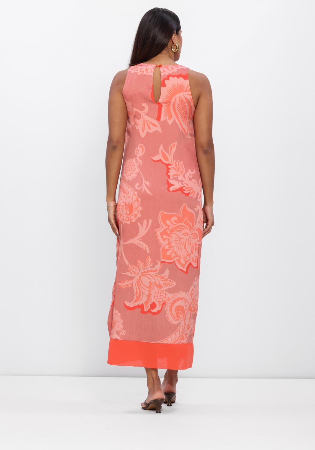 Pink Baby Rosalind floral print maxi dress in coral pink, flowing fabric with a fitted bodice and vibrant floral pattern.
