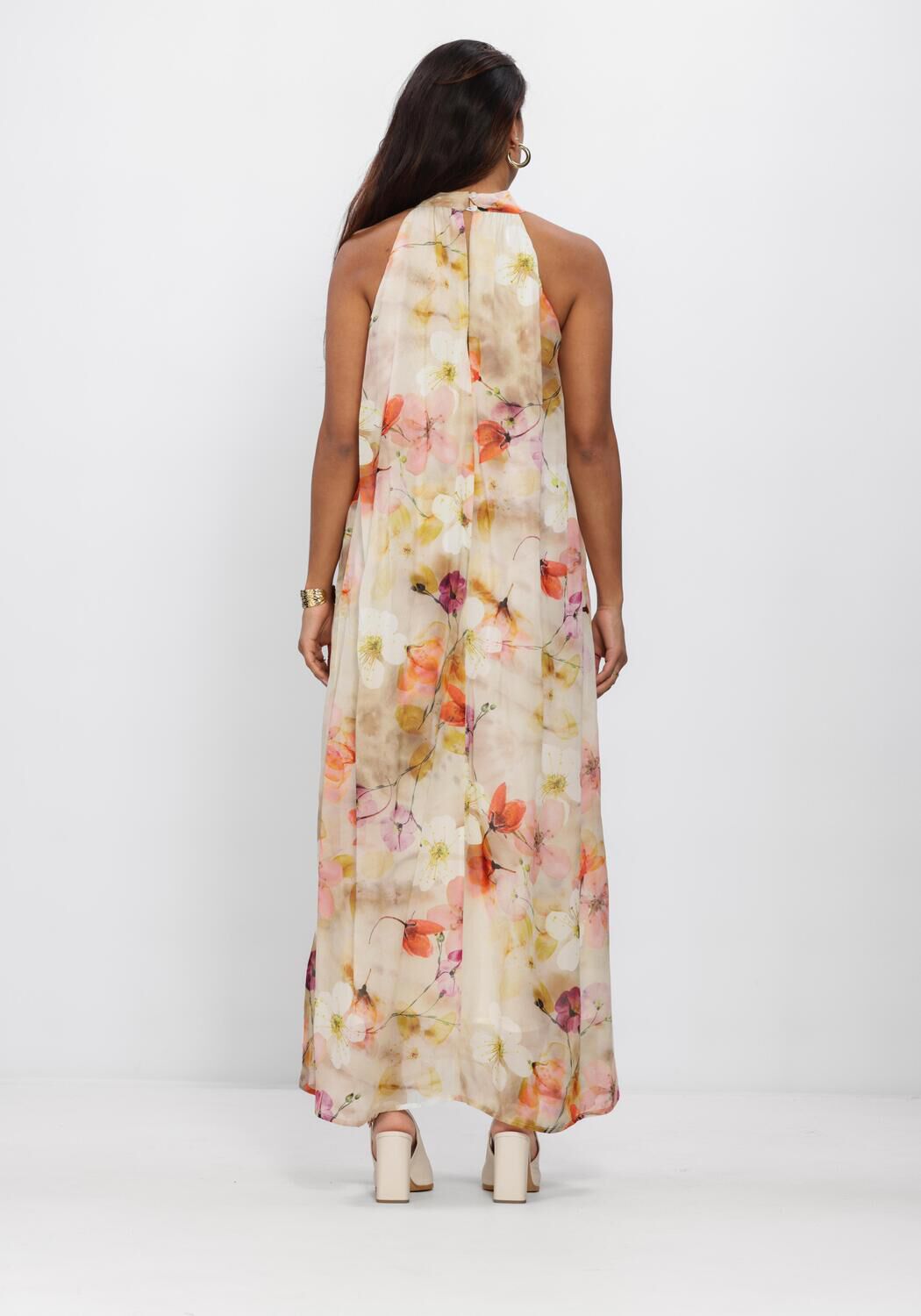 Pink Baby Elara Floral Halterneck Maxi Dress in ivory with colorful floral pattern, flowing fabric, and halter neckline.