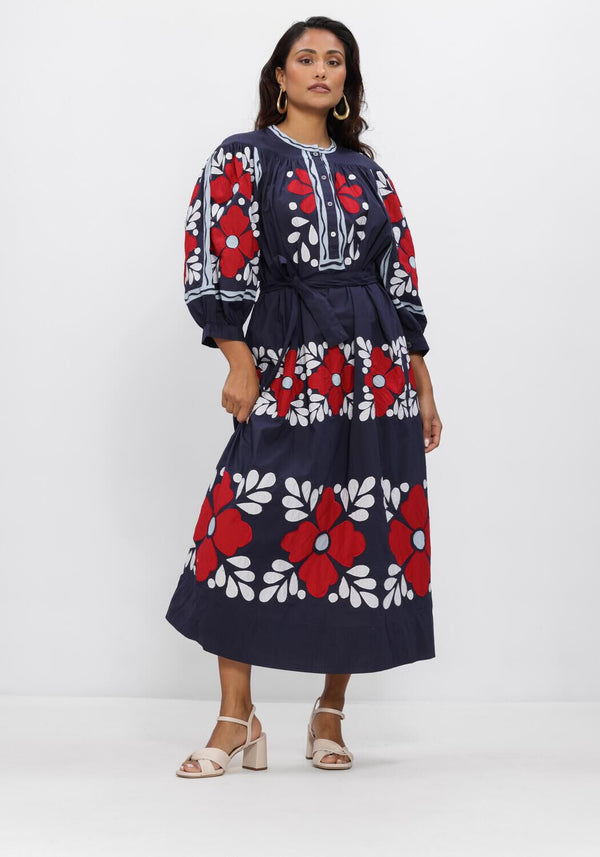 Pink Baby Elena navy floral embroidered midi dress with delicate detailing and flowy fabric, perfect for elegant occasions.