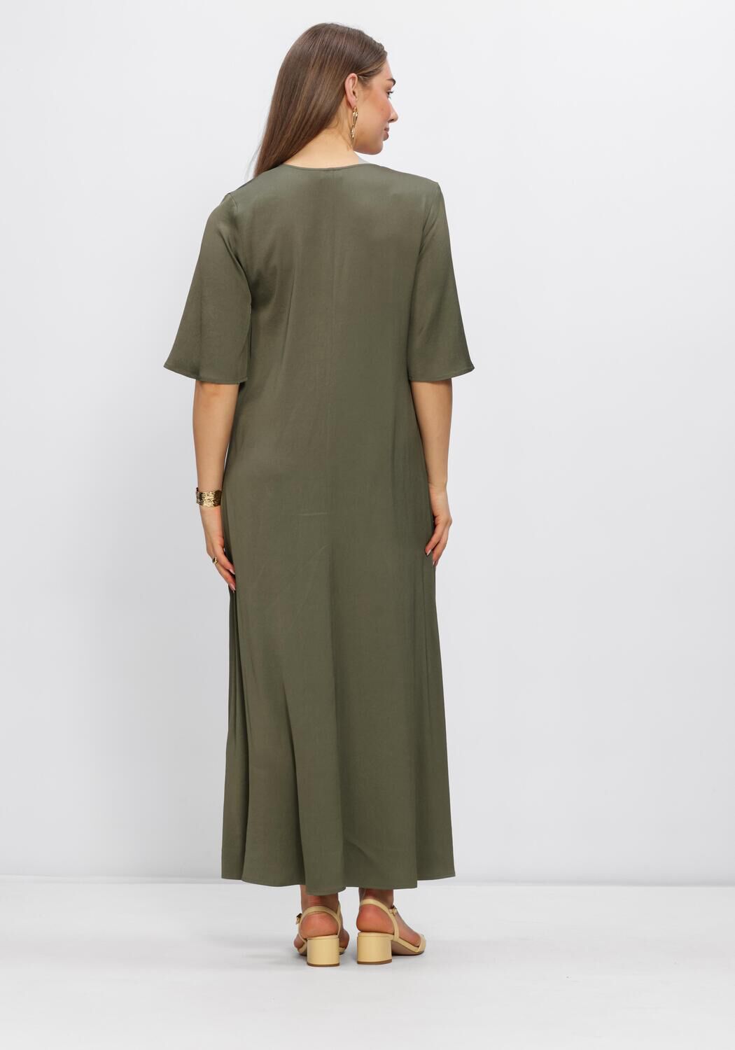 Olive green Alissa V-neck flowing maxi dress by Pink Baby displayed on a hanger with soft fabric drape.